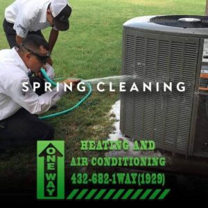Two technicians cleaning a commercial or residential HVAC system.